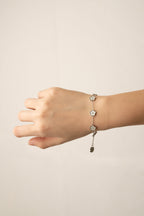 Model wearing MNML Floral Clovers Bracelet on wrist — delicate clover bracelet everyday Malaysia in silver