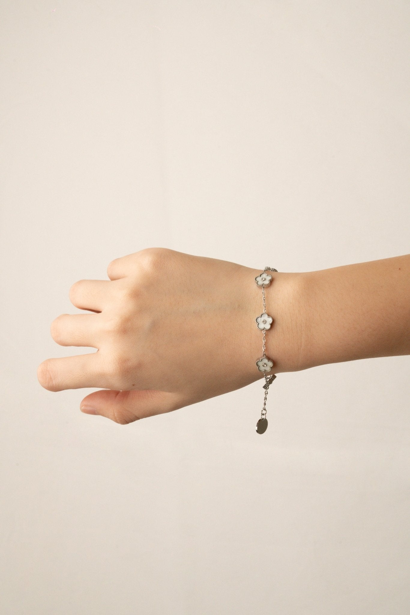 Model wearing MNML Floral Clovers Bracelet on wrist — delicate clover bracelet everyday Malaysia in silver