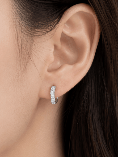 Flowy pavé huggie worn snug at the ear lobe
