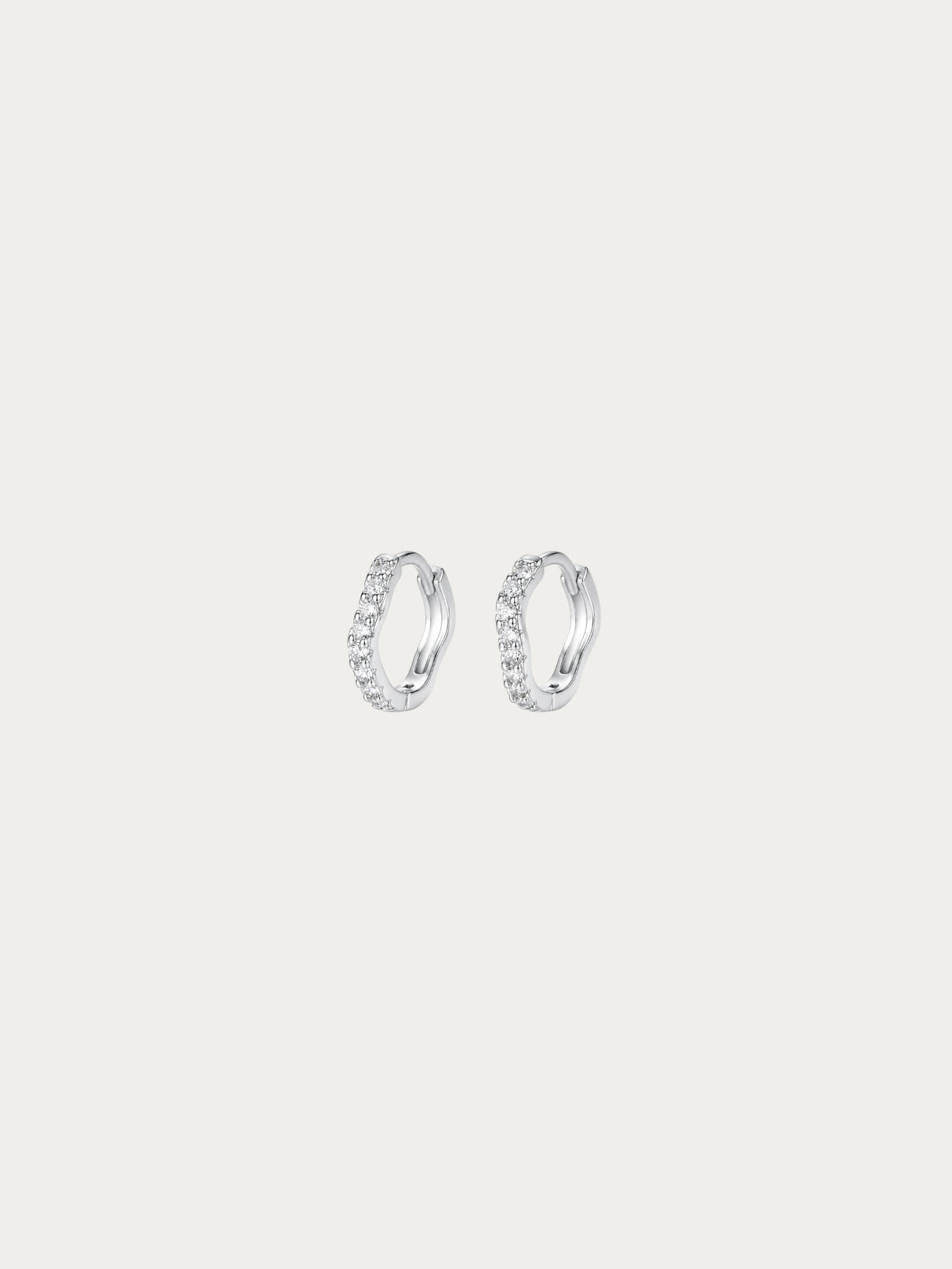 Flowy Paved Essential Huggie Earrings with a single wavy row of pavé CZ in rhodium-plated 925 sterling silver, front view
