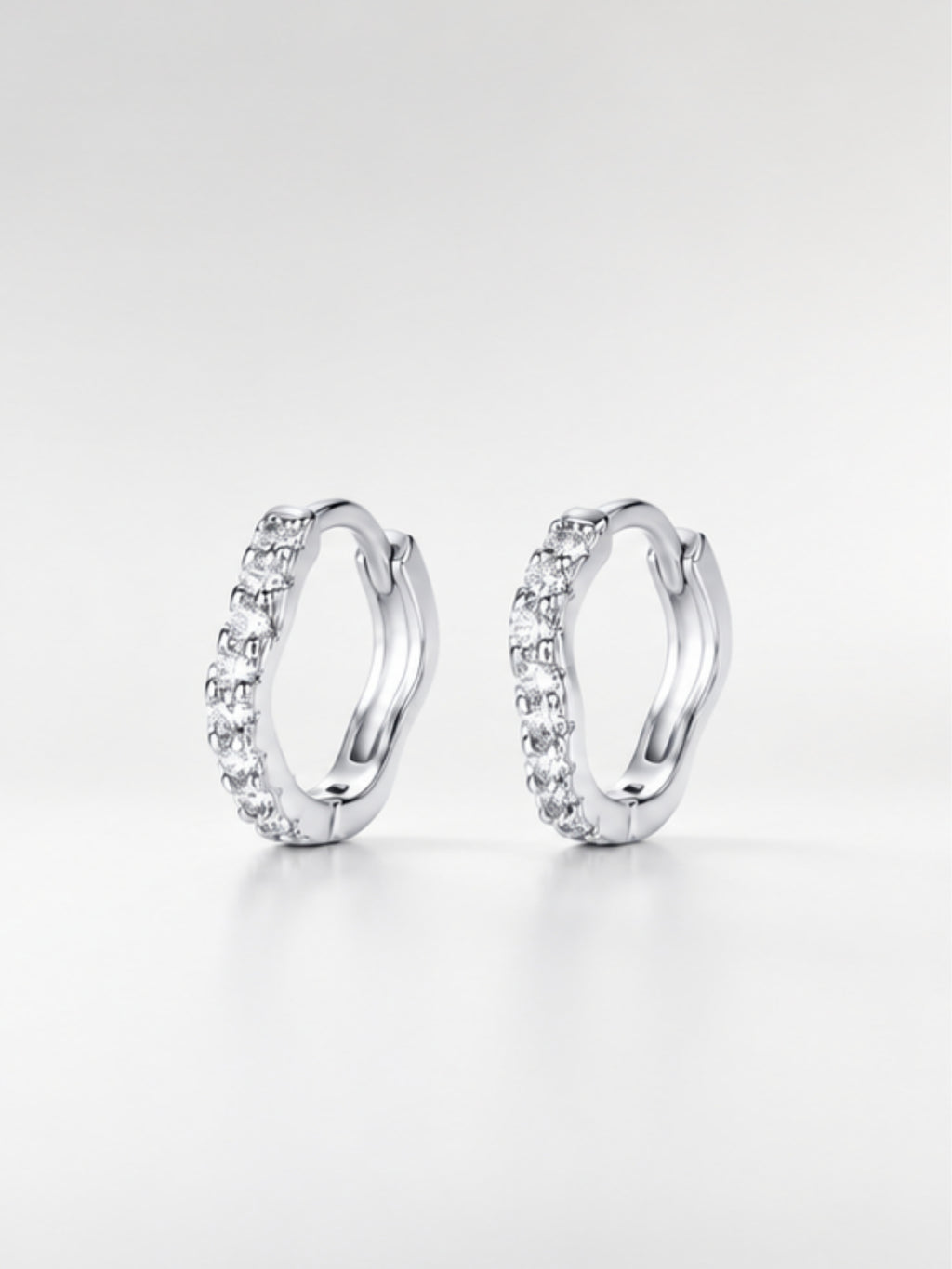 Close-up of the gently curving row of pavé cubic zirconia on the Flowy huggie