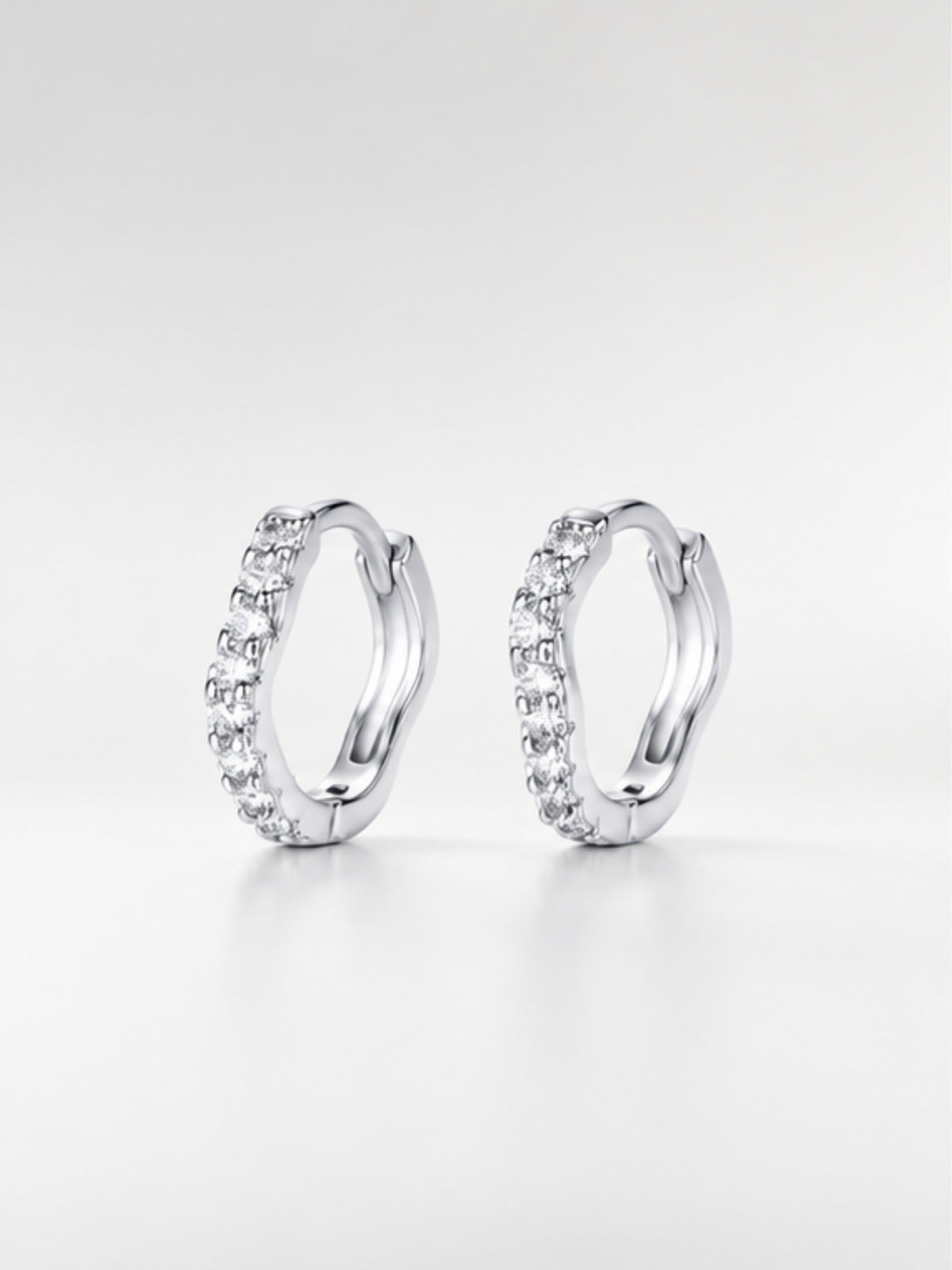 Close-up of the gently curving row of pavé cubic zirconia on the Flowy huggie