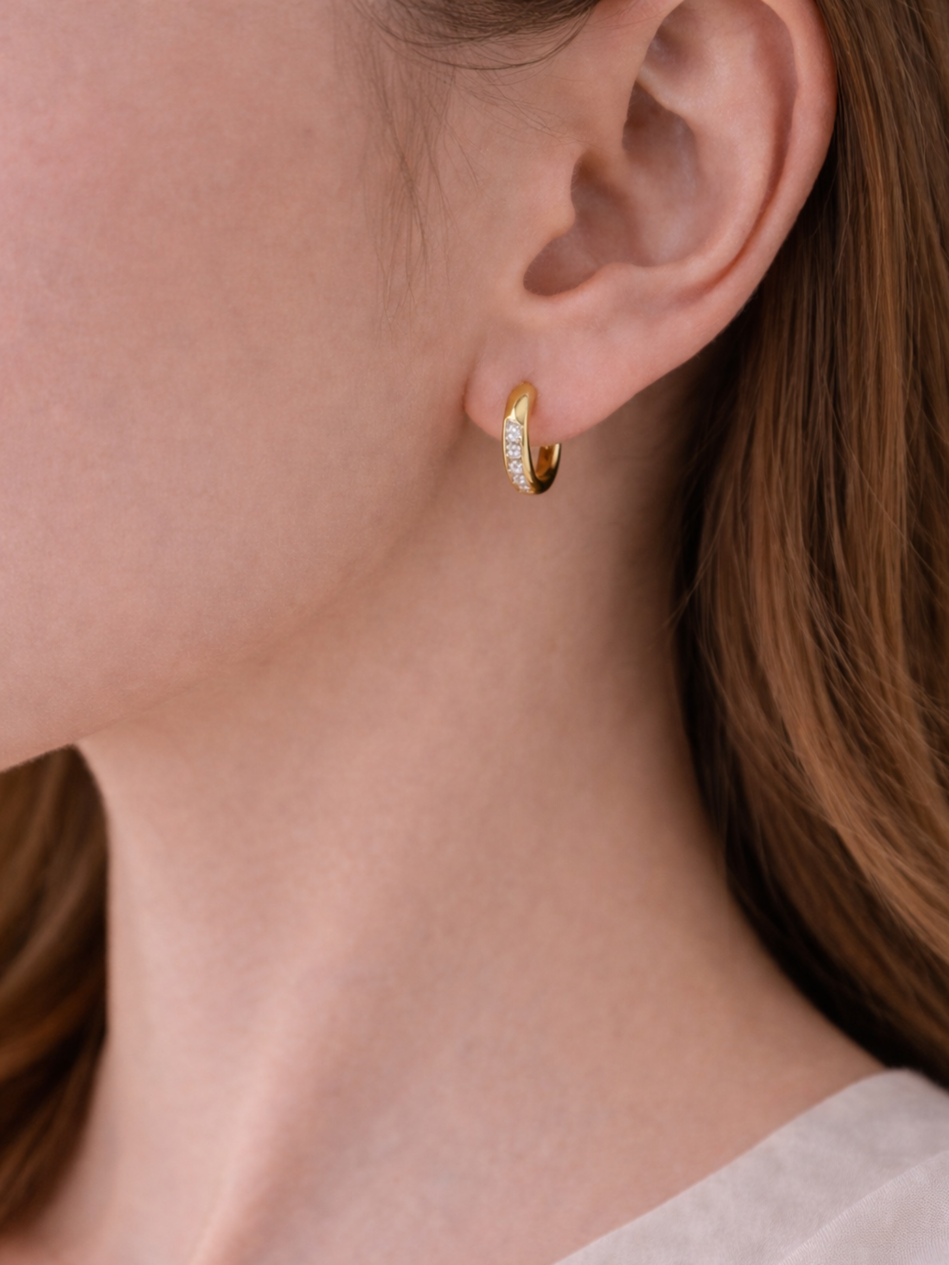 Side view of Giovanna huggie earring showing front-set CZ