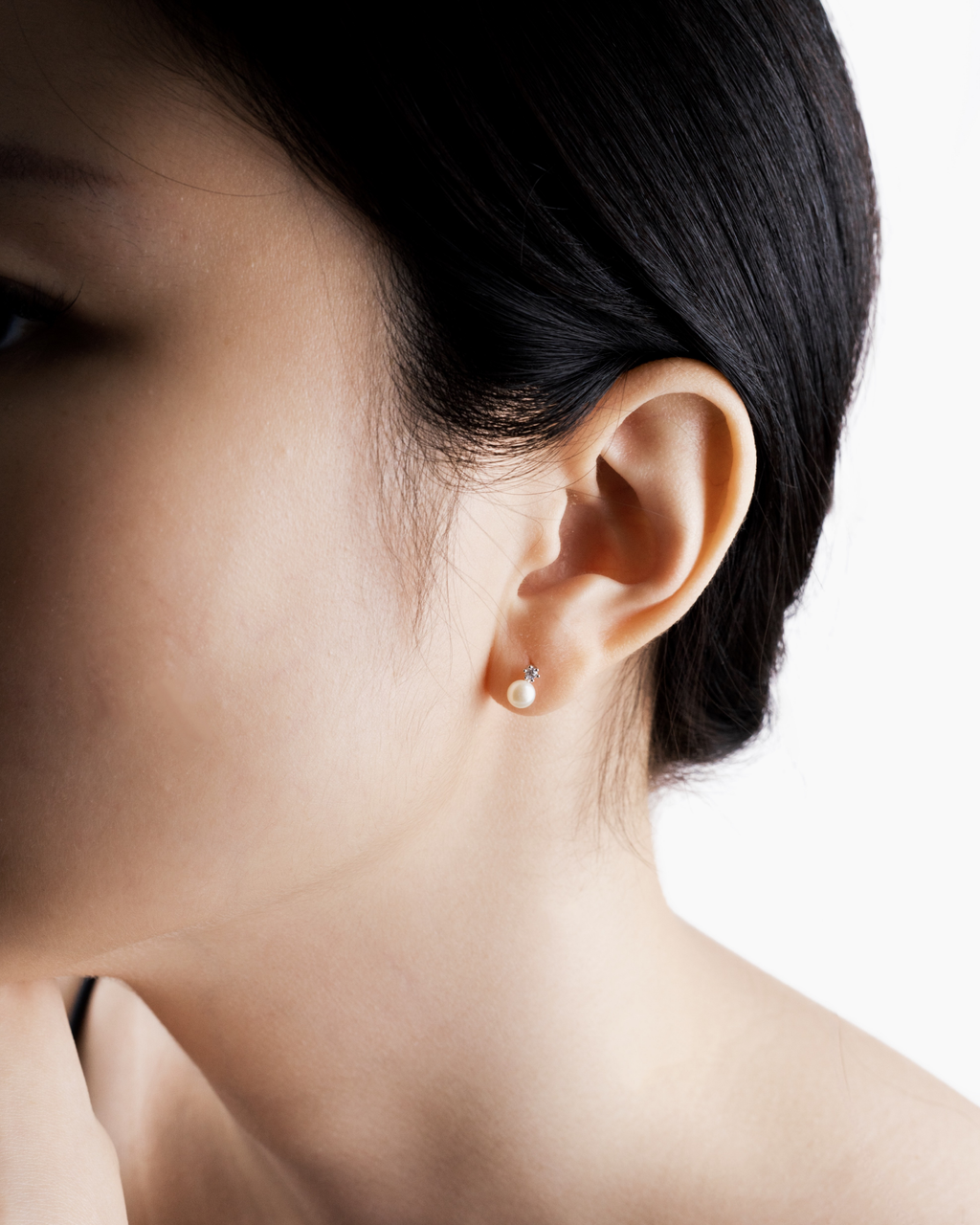 Hikari pearl drop earring worn alone on a single piercing