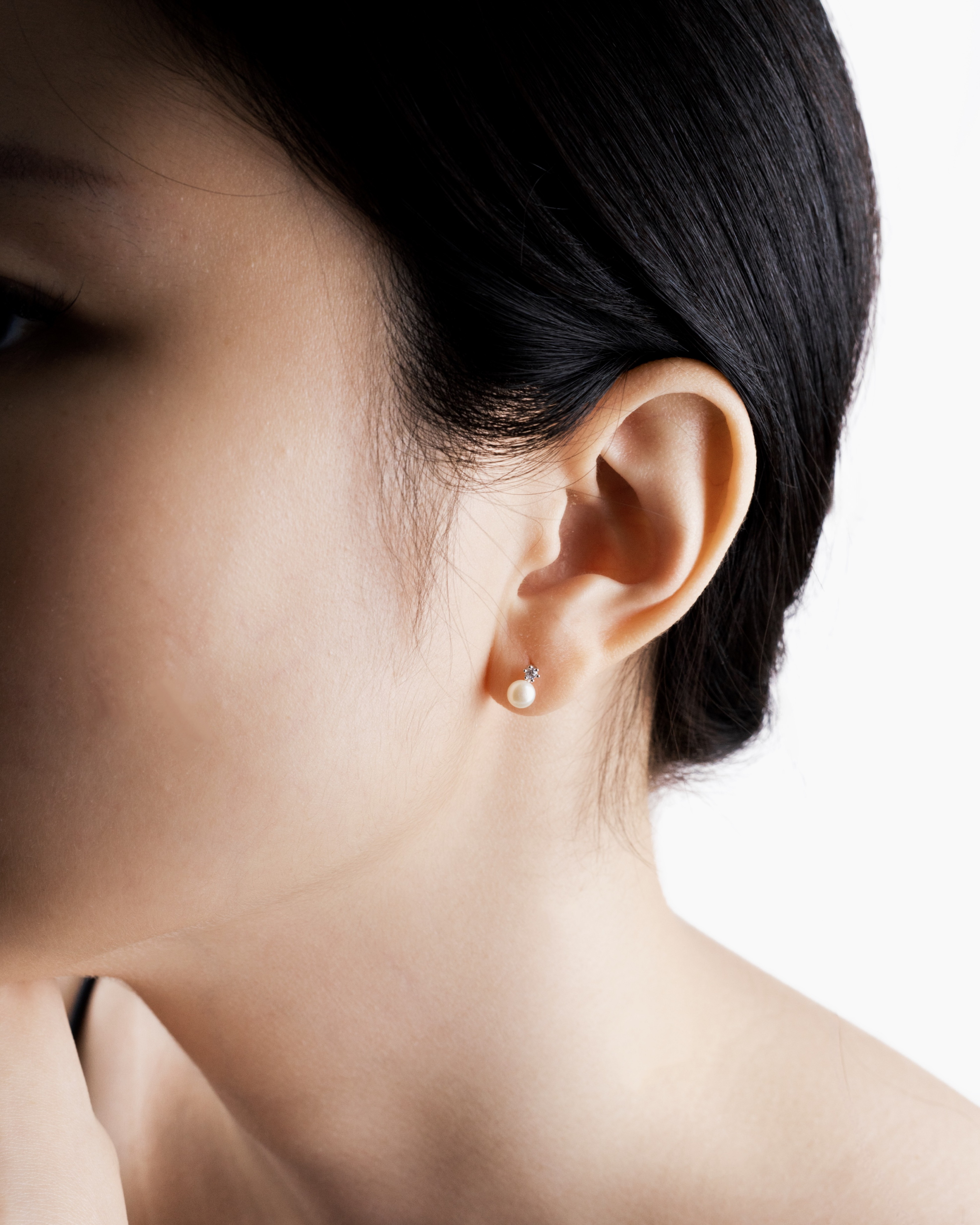 Hikari pearl drop earring worn alone on a single piercing
