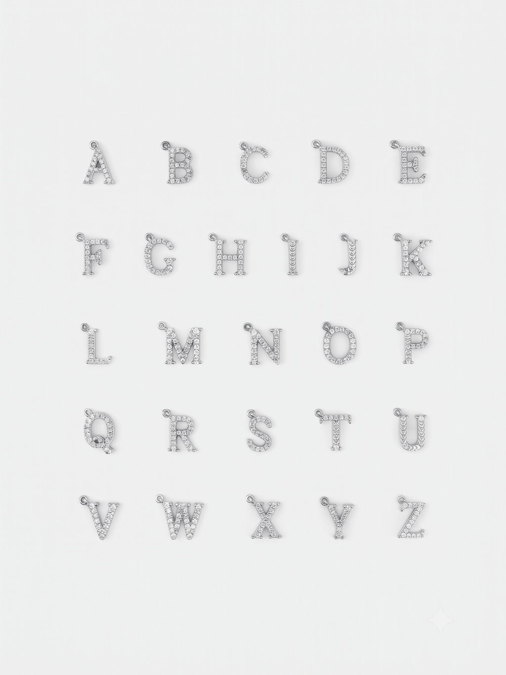 Initial alphabet pendants from A to Z laid out in a flatlay