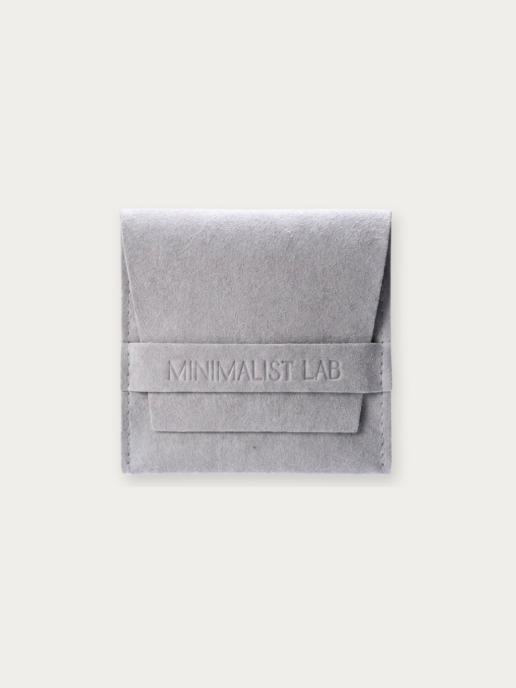 MNML grey suede jewellery pouch with debossed Minimalist Lab branding, front view