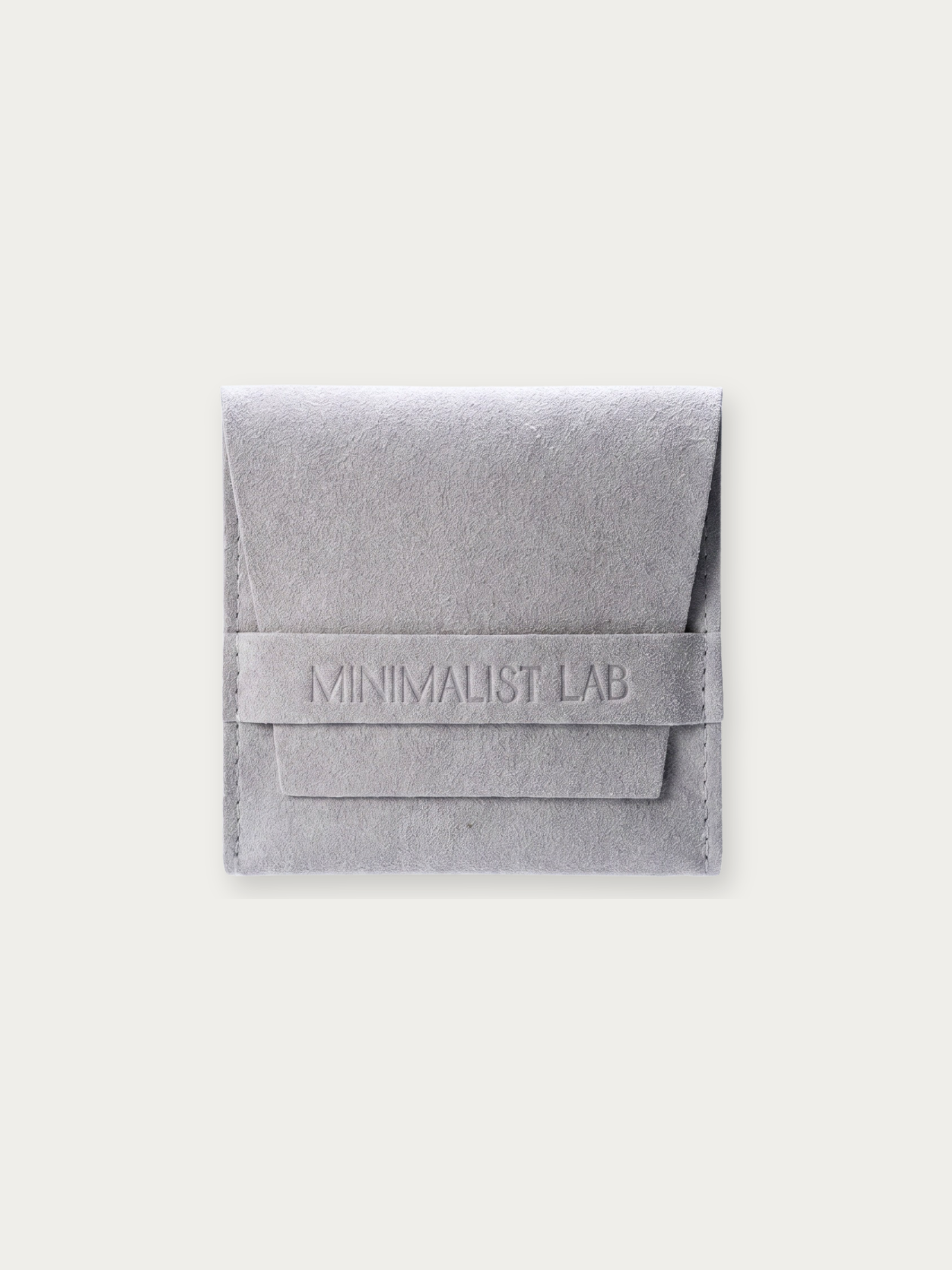 MNML grey suede jewellery pouch with debossed Minimalist Lab branding, front view
