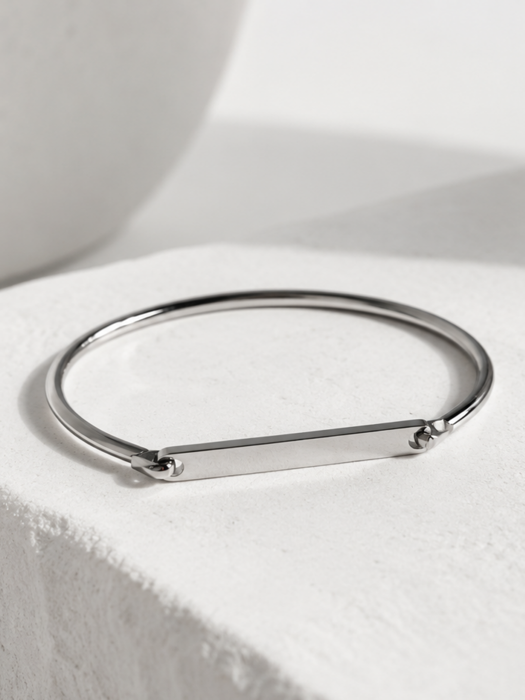 Close-up of a name engraved on the Julius bangle's 4cm bar