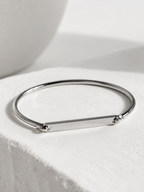 Close-up of a name engraved on the Julius bangle's 4cm bar