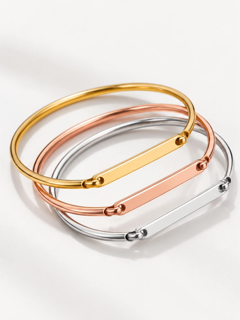 Julius bar bangles in gold, rose gold and silver side by side
