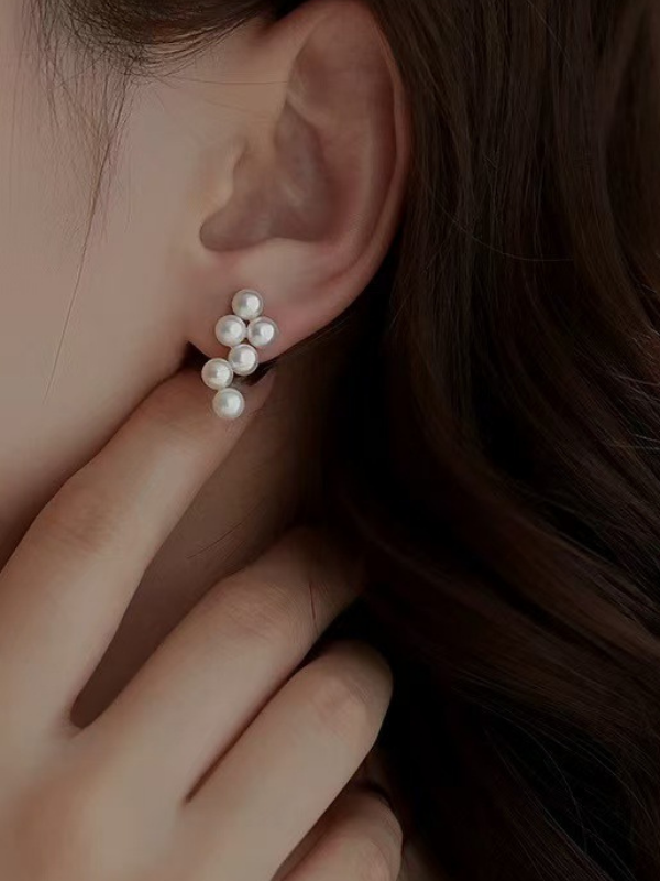 Kaela Pearl Earrings worn on the ear, cluster pearl design