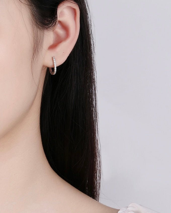 LEVI oval hoop earring worn on the ear