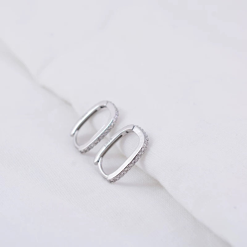 Close-up of LEVI oval hoop earring in Silver finish