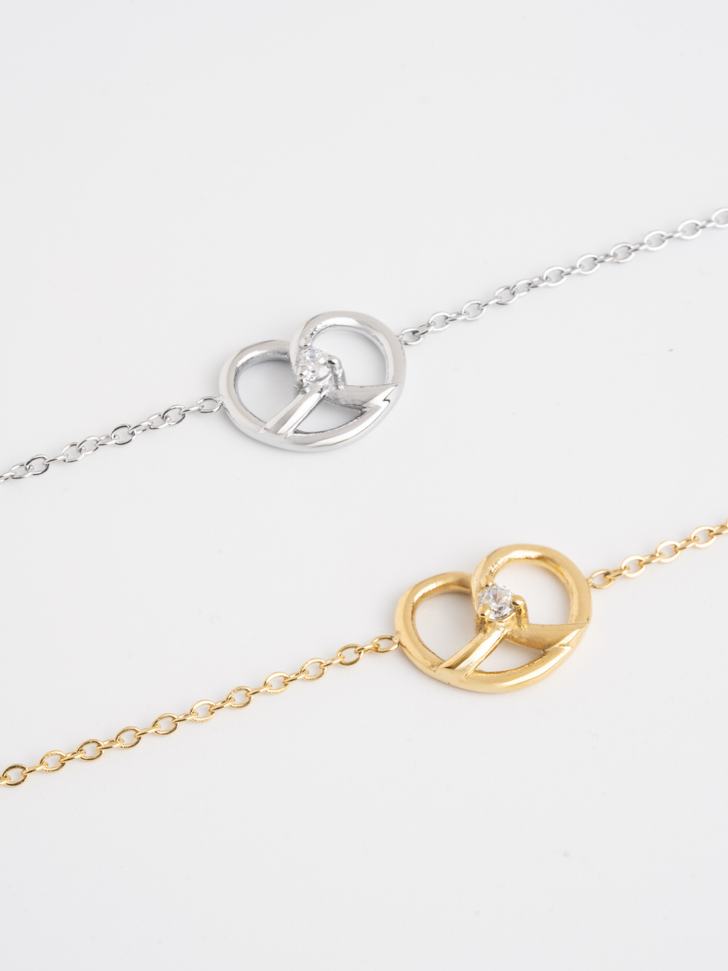 MNML Little Pretzel Necklace in silver and gold flat lay — titanium pretzel jewelry Malaysia
