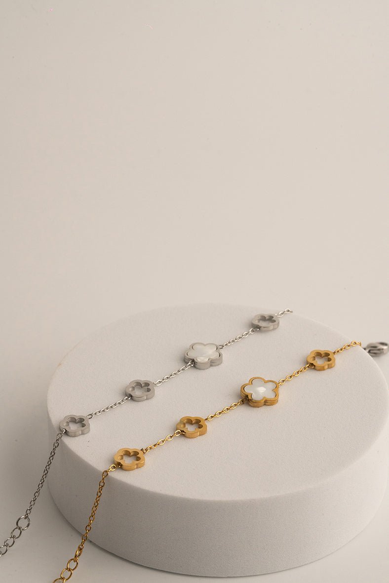 Hollow floral charm detail on MNML Luna Blossom Radiance Bracelet — airy five-petal titanium charms