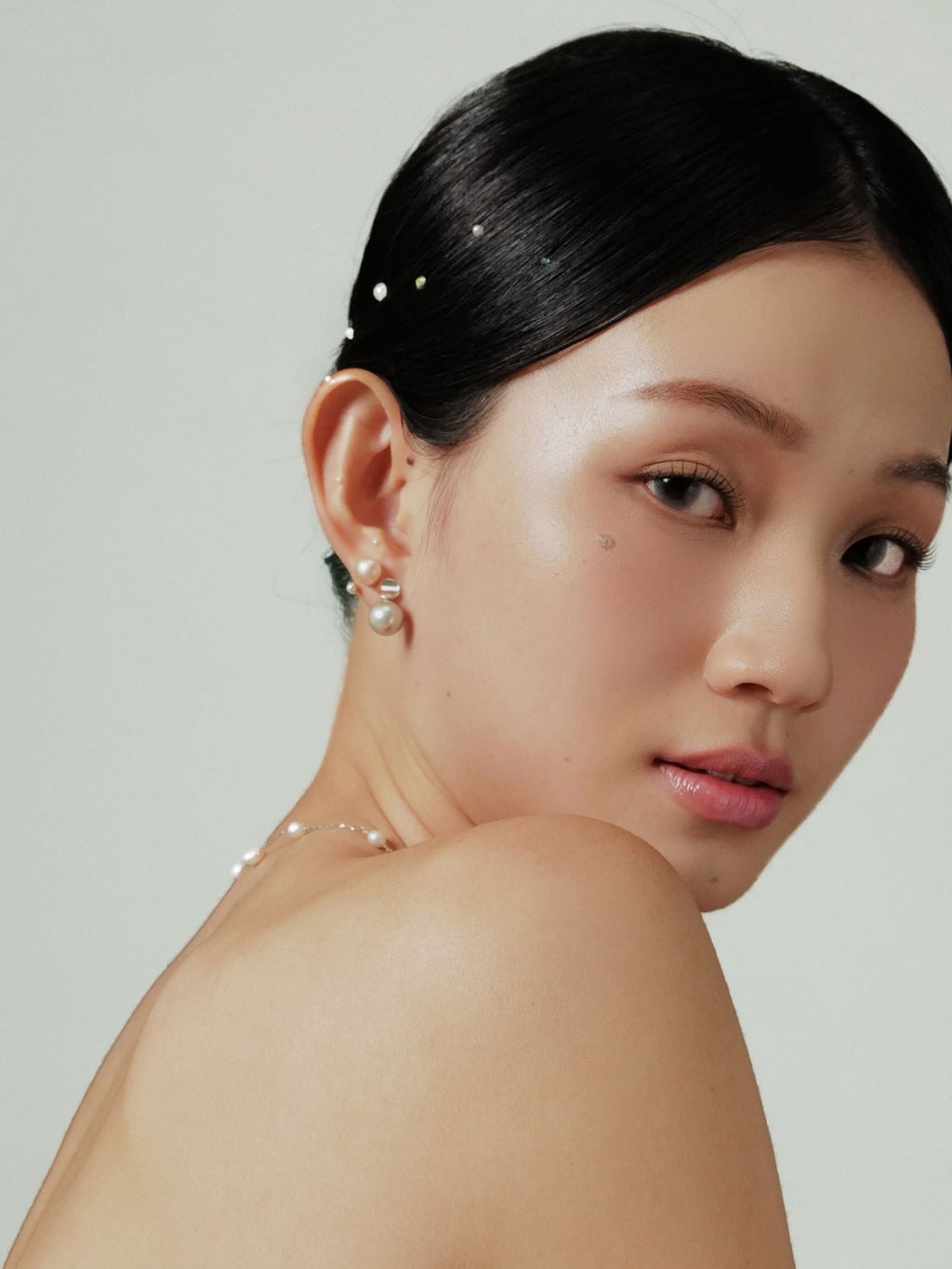 Luna pearl earring worn on the ear