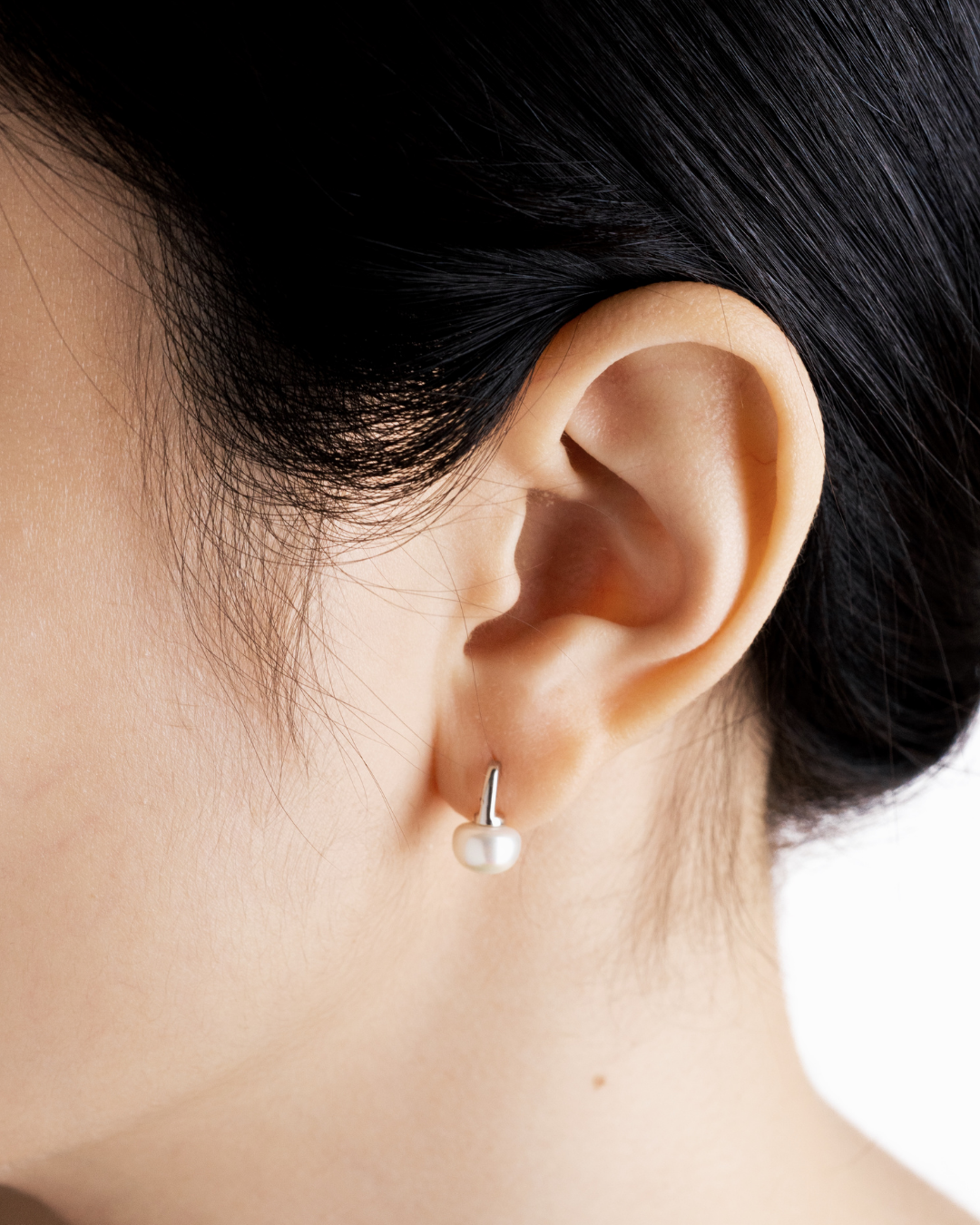 Miyu pearl drop stud earring worn on the ear