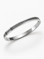 Close-up of the curb chain inset into the channel of the Mono Chain Bangle