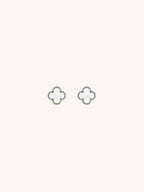 MNML Mother of Pearl Mini Clover Stud Earrings pair flat lay — silver and gold titanium clover studs