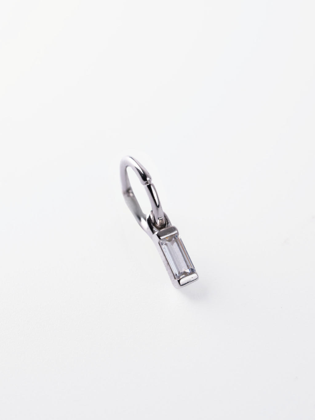Drop movement detail on MNML Noa Baguette Drop Single Hoop — baguette pendant swing detail