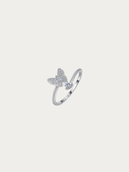 Odette ring with a moissanite butterfly cluster and round moissanite solitaire on an open adjustable band, front view