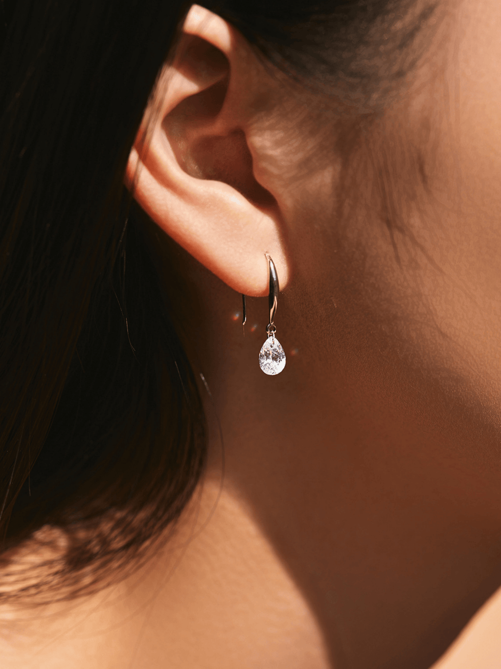 Side view of Pearluxe teardrop earring showing hook and stone