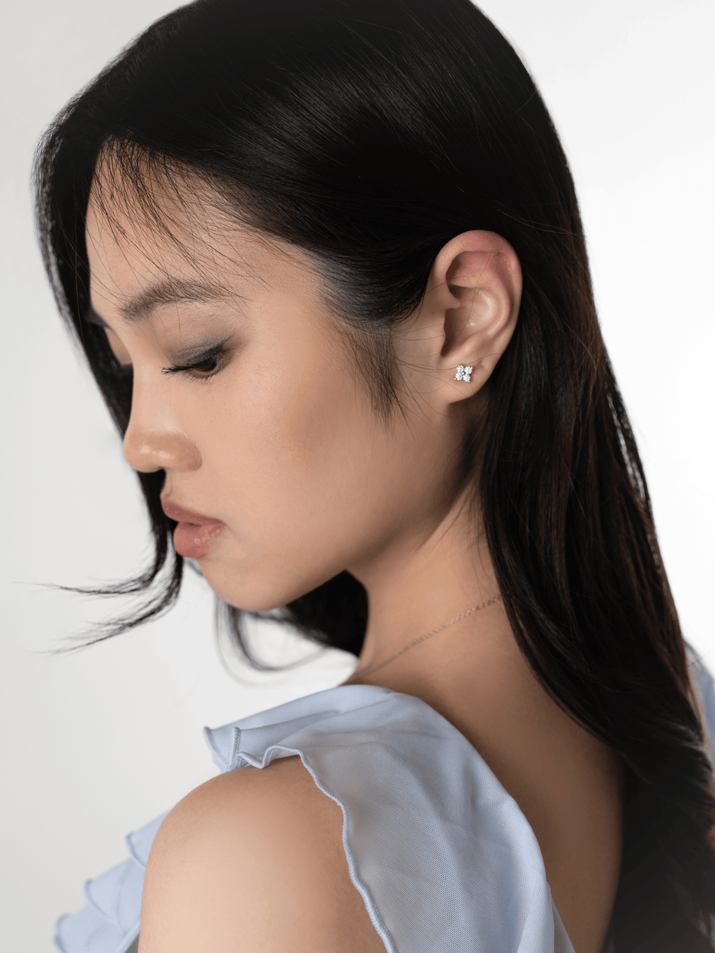 Piper Bloom moissanite clover stud worn on the ear lobe