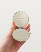MNML Reflection Pocket Mirror open in hand, showing mirror and engraved quote
