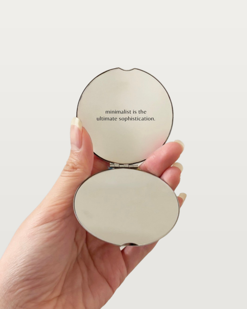 MNML Reflection Pocket Mirror open in hand, showing mirror and engraved quote