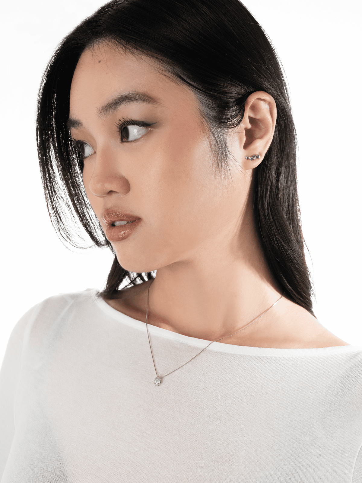 Reverie moissanite teardrop necklace worn at the neckline