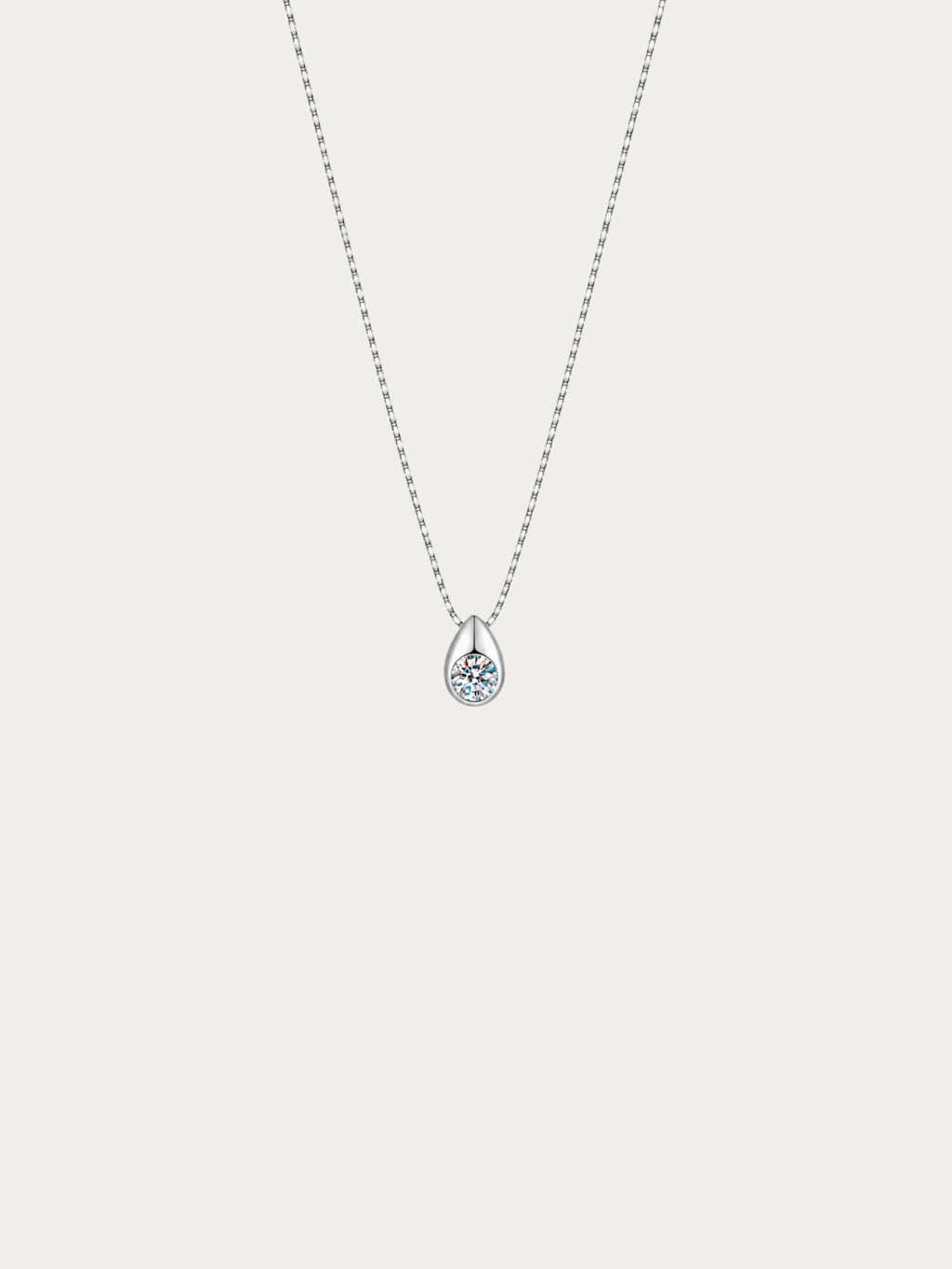 Reverie necklace with a round moissanite bezel-set in a teardrop on a 925 sterling silver box chain, front view
