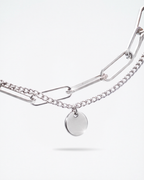 Close-up of 8mm engravable disc charm on MNML Rory Paperclip Bracelet — personalised disc detail