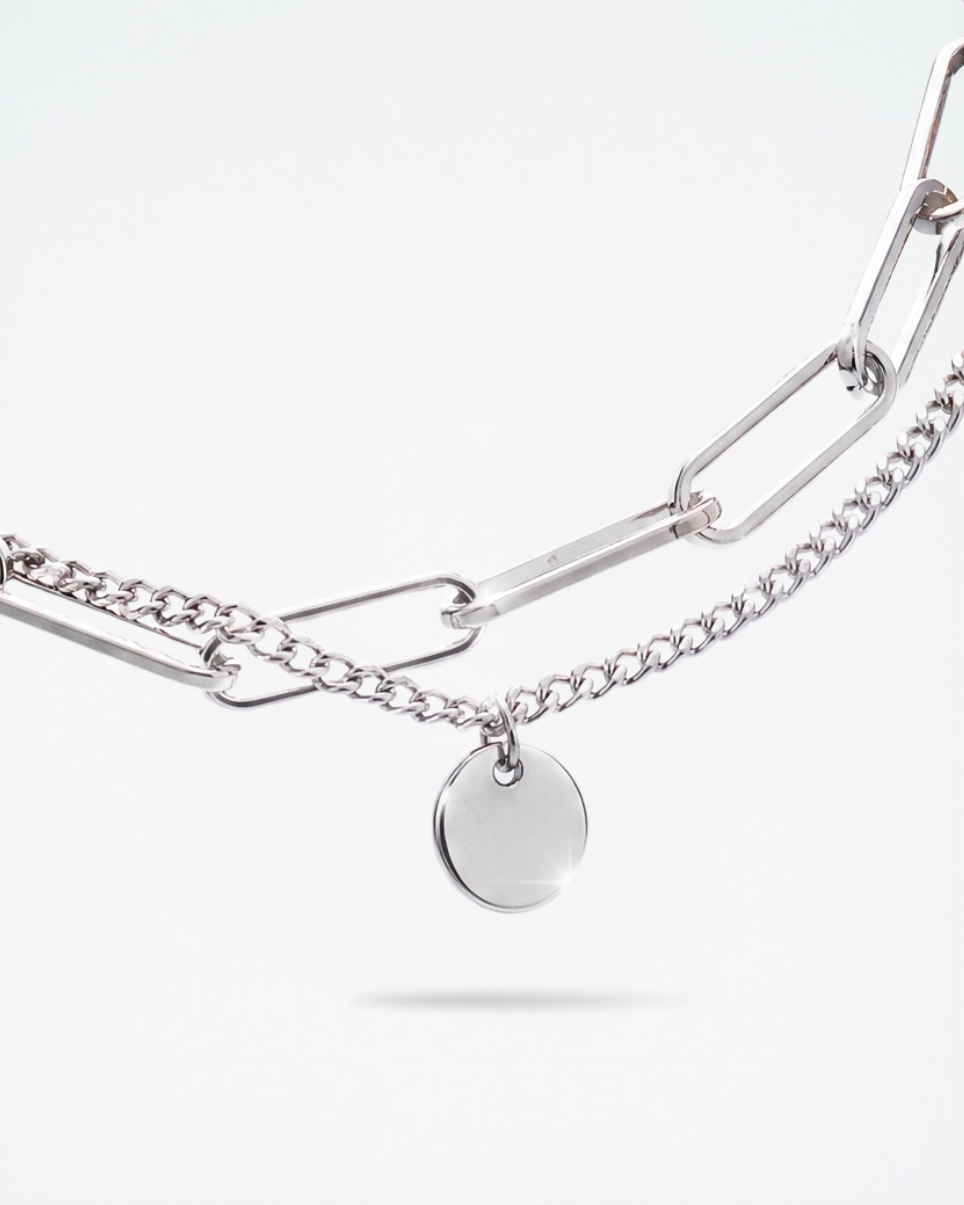 Close-up of 8mm engravable disc charm on MNML Rory Paperclip Bracelet — personalised disc detail