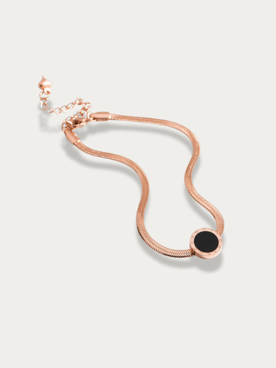 Close-up of Roman numeral disc pendant on Rose anklet