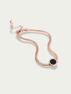Close-up of Roman numeral disc pendant on Rose anklet
