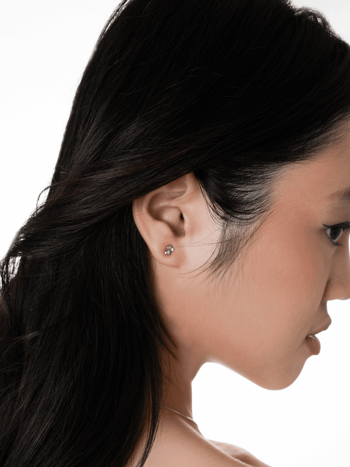 Routine Love two-heart cluster stud worn on the other ear lobe