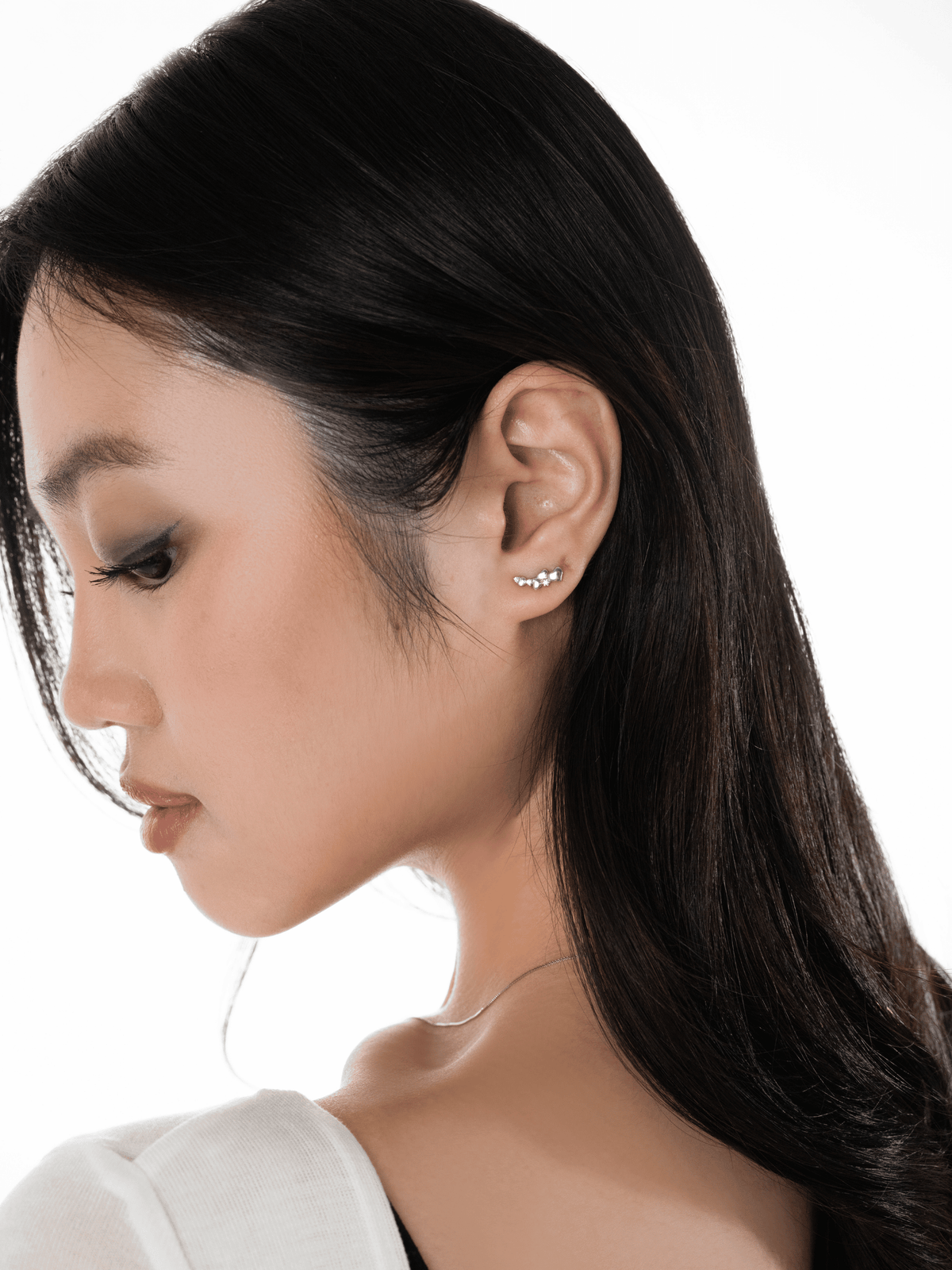Routine Love four-heart trail stud worn on one ear lobe