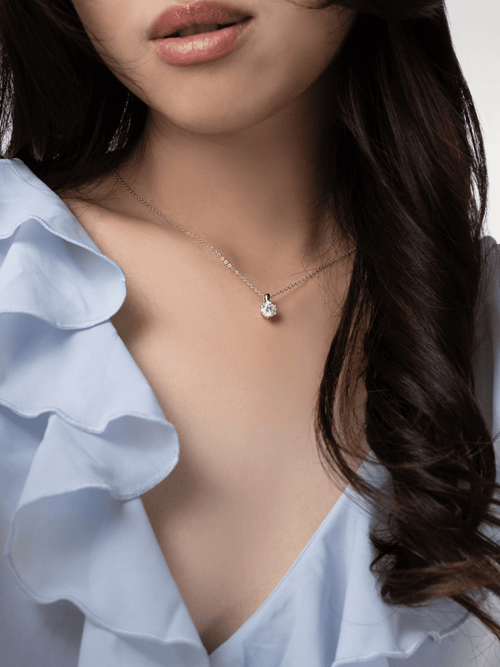 Sawyer moissanite solitaire necklace worn near the collarbone