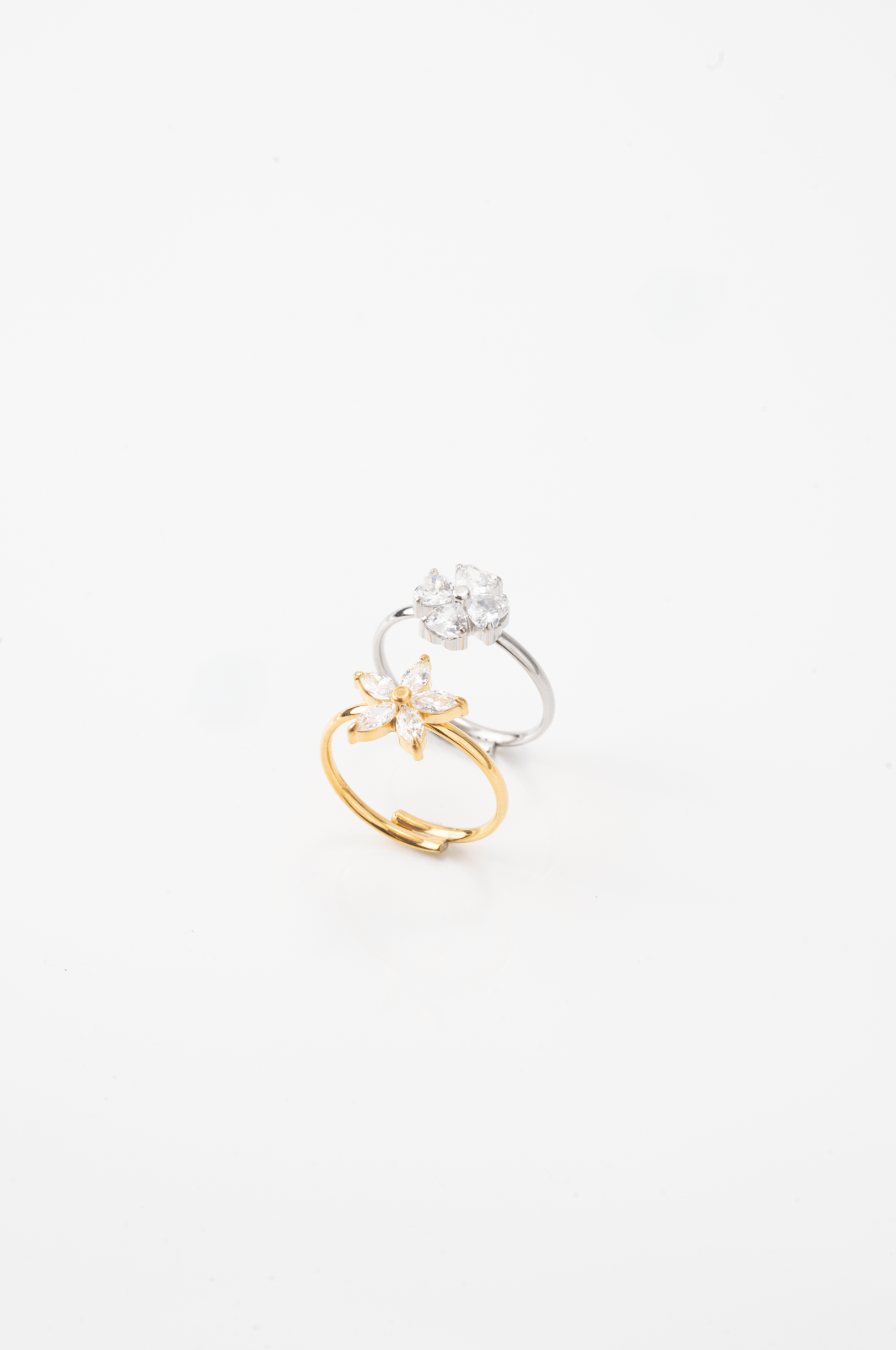 MNML Secret Garden CZ Flower Ring in silver and gold flat lay — two colour variants titanium