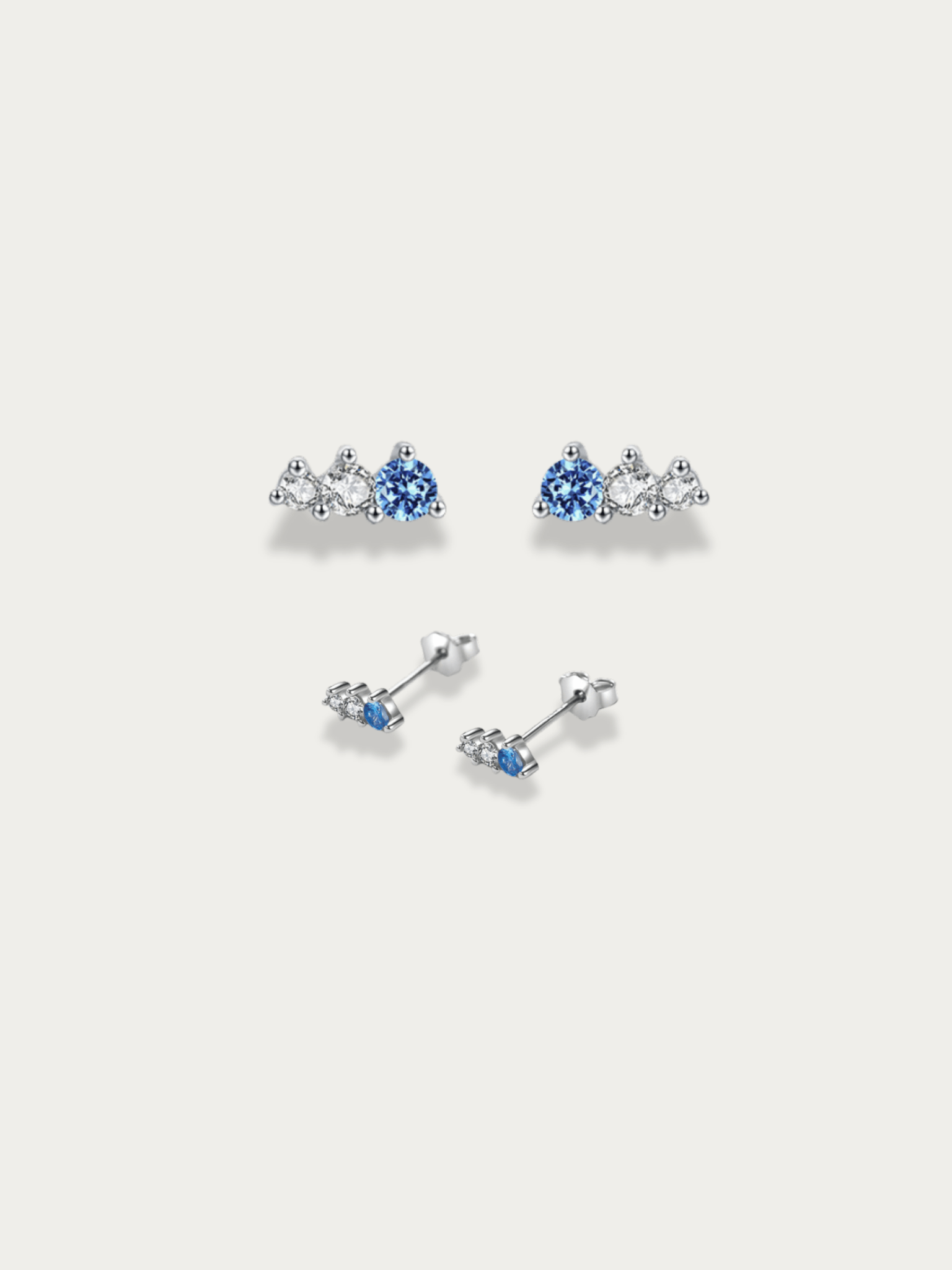 Sky Glimmer Stud Earrings with three-stone blue and CZ cluster