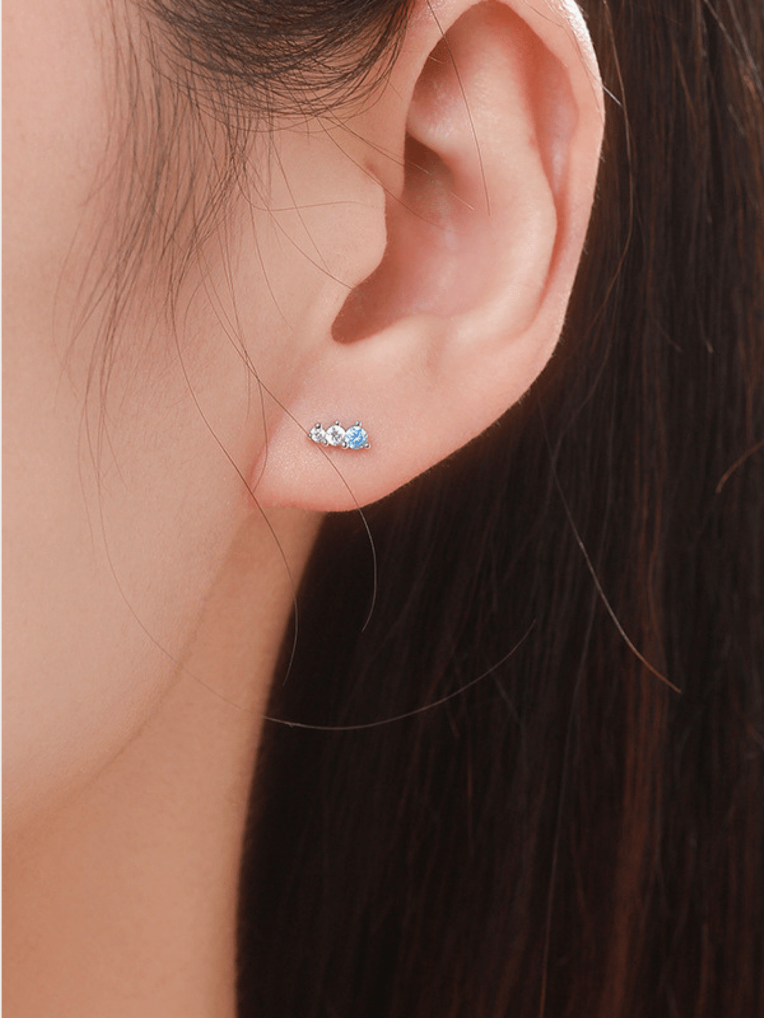 Sky Glimmer stud earring worn on the ear