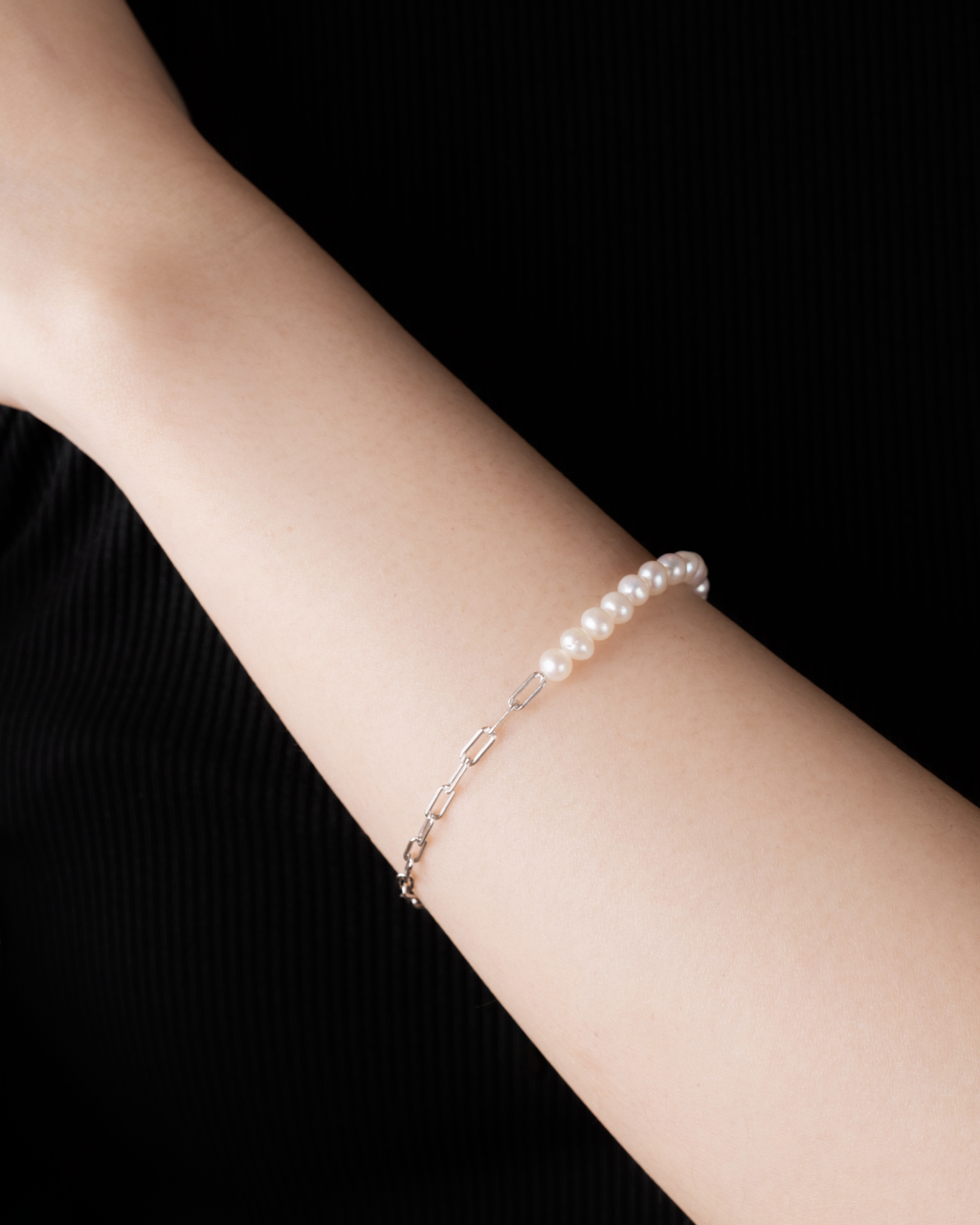 Close-up of paperclip chain section on Sora bracelet