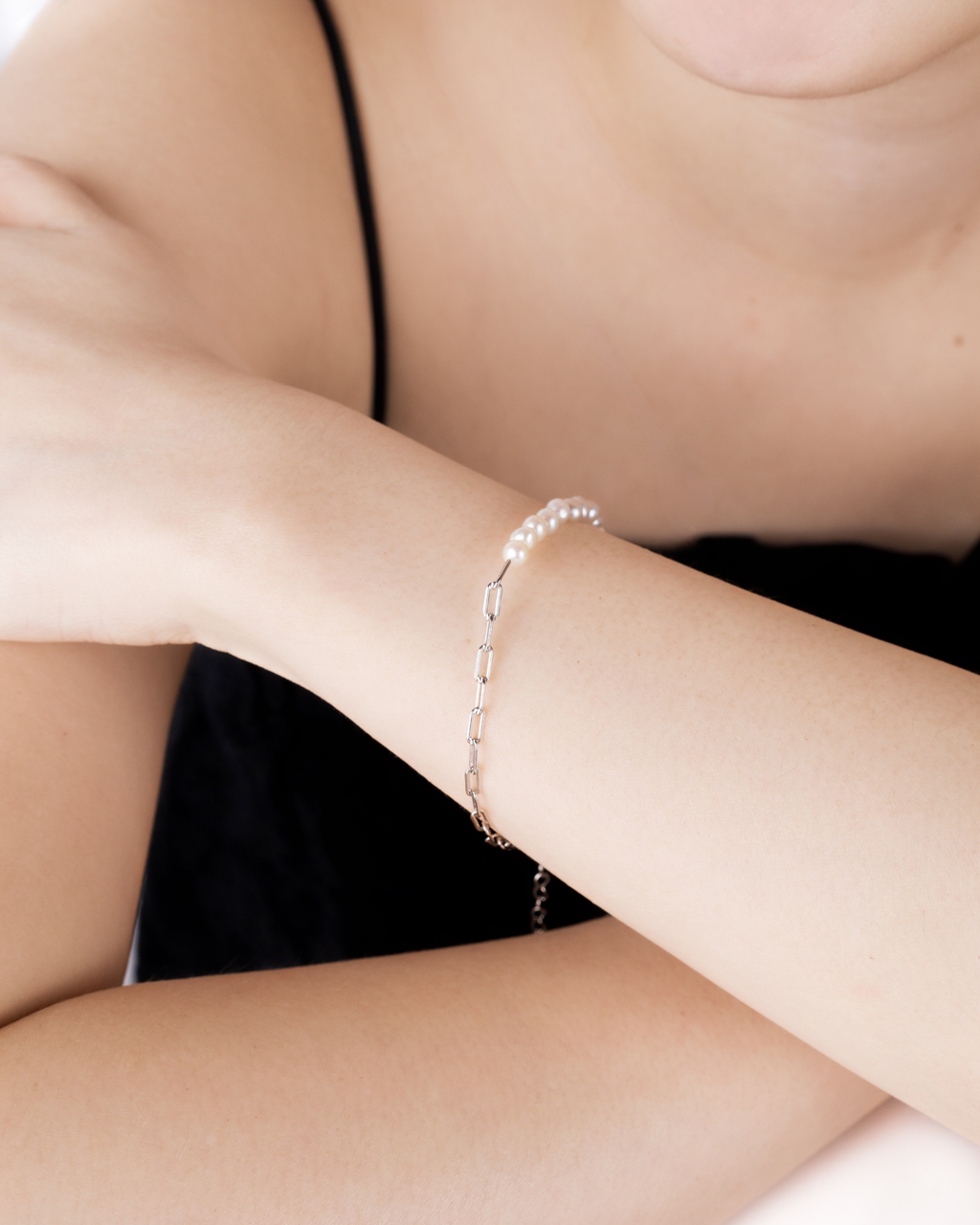 Sora pearl paperclip bracelet worn on the wrist