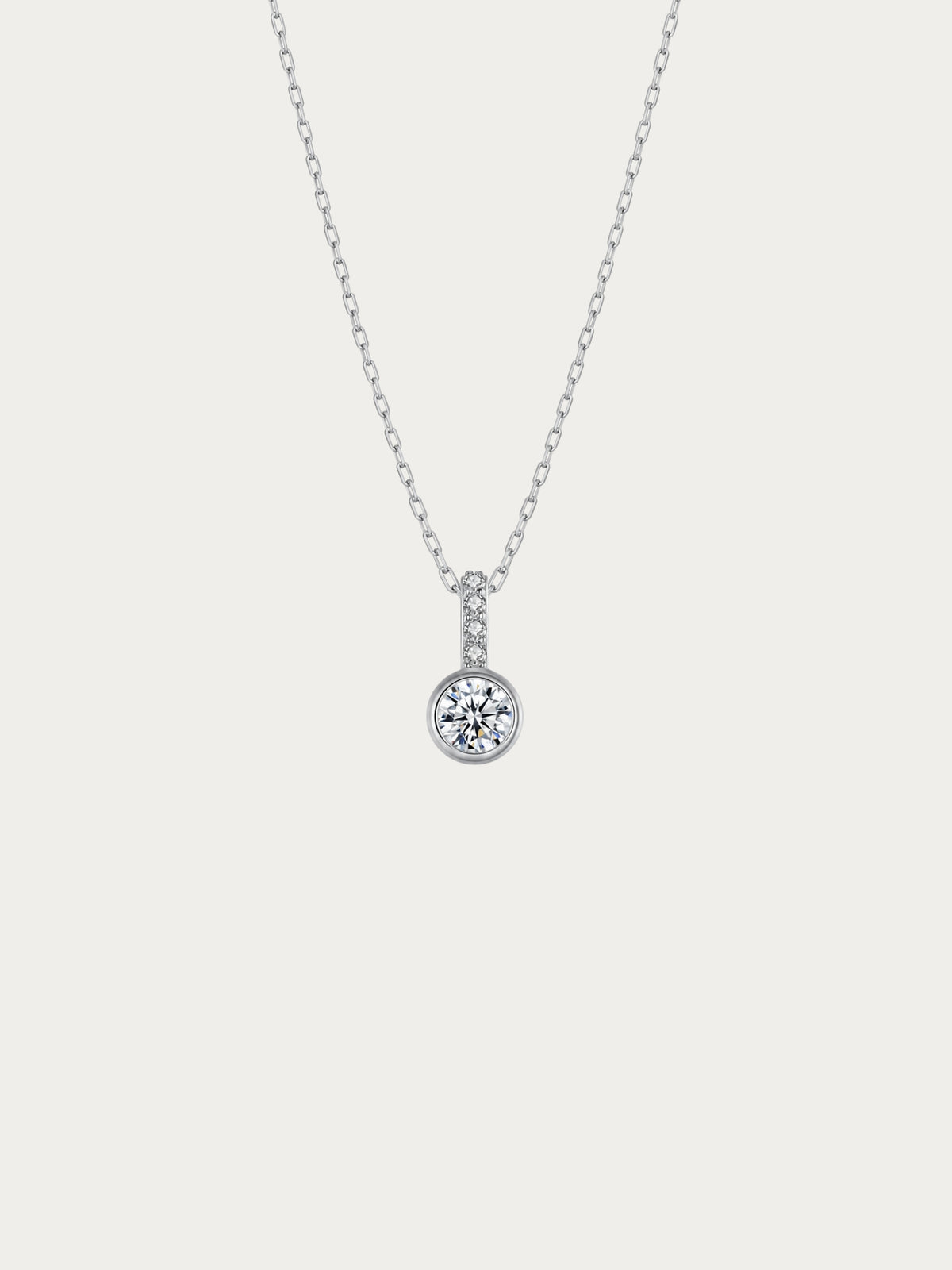 Sunrise solitaire necklace with a bezel-set round CZ under a pavé bail in rhodium-plated 925 sterling silver, front view