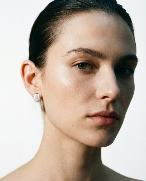Tauri bean dome stud earring worn on the ear