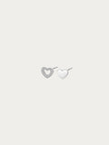 Teeny Tiny asymmetrical heart stud pair in rhodium-plated 925 silver, with an open pavé heart and a solid heart side by side