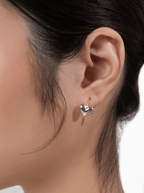 Close-up of the smooth, plump polished heart on the Tender Hearts earring