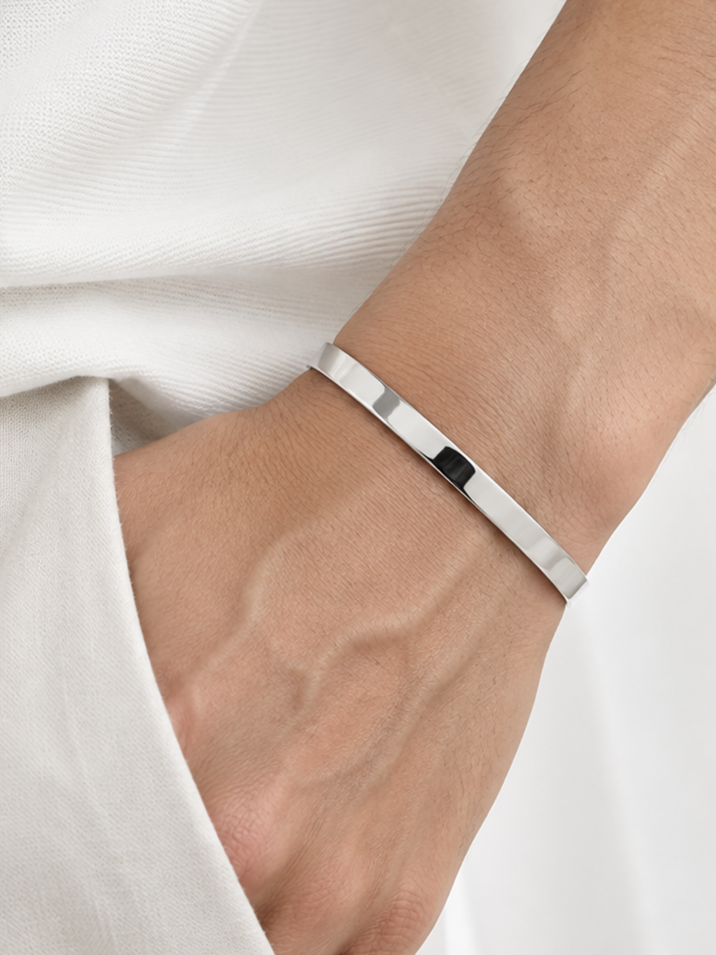 Titus open cuff bangle worn on a man's wrist