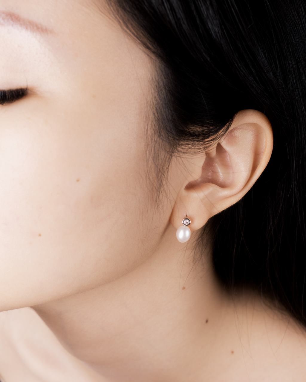 Tsuki pearl drop earring worn on the ear